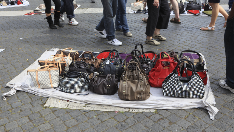 Selling fake designer bags on the street in Rome, Italy